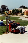 Student Resting on Chair Next to Signs