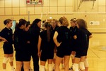 Volleyball Coach and Players in Huddle