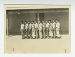 Young men standing in front of barrack