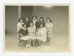Eight women in front of barrack