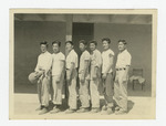 Seven young men in front of barrack