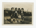 Young women standing outside barrack